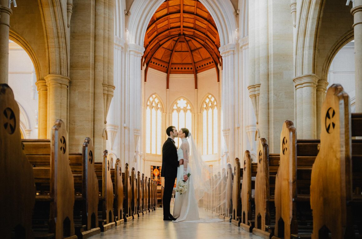 Bride and groom kissing in church