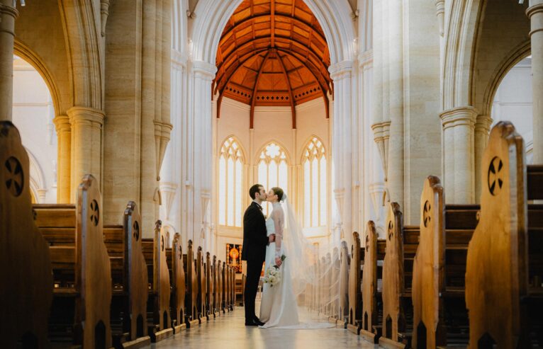 Bride and groom kissing in church