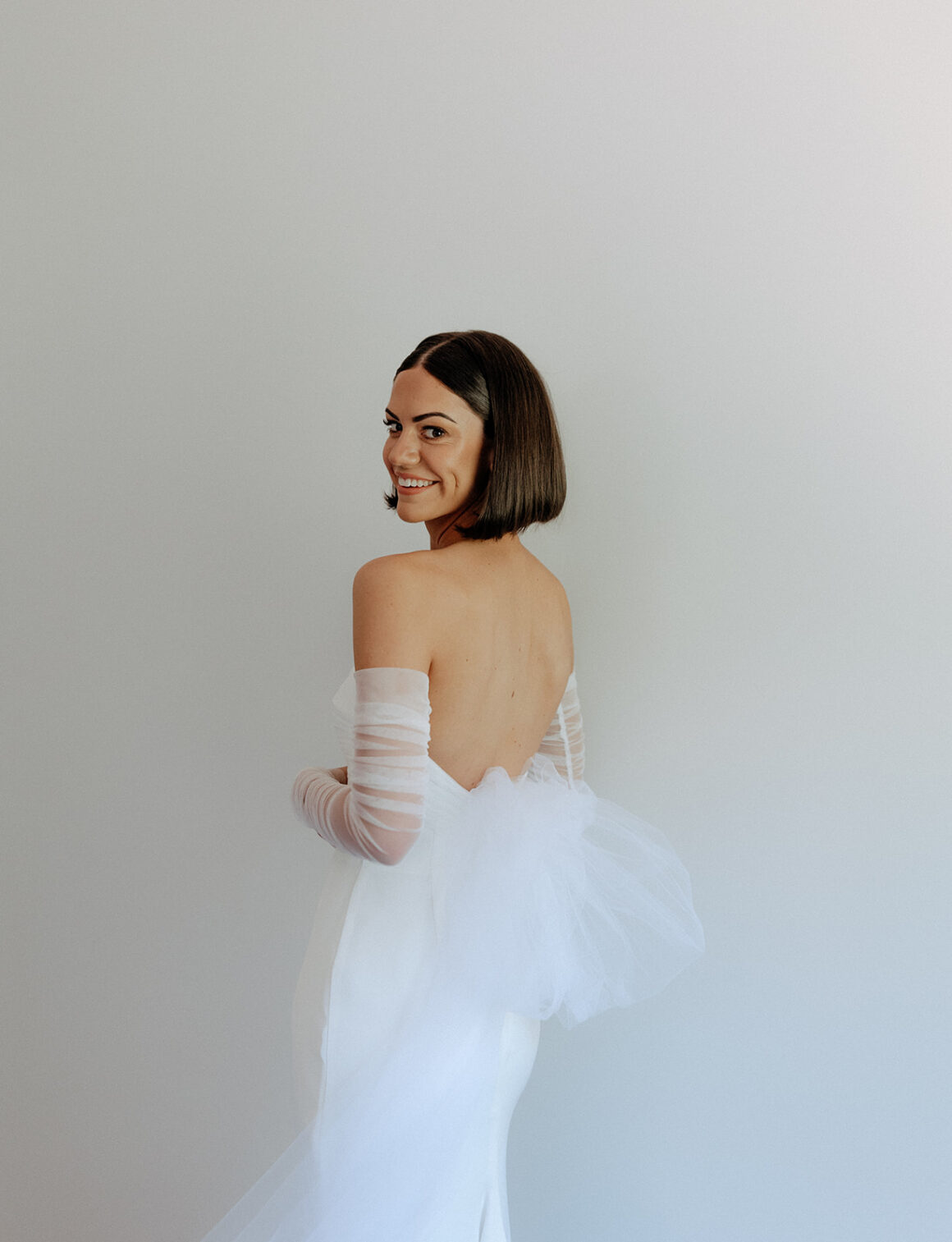 Bride in KYHA Studios wedding dress with custom tulle bow detail