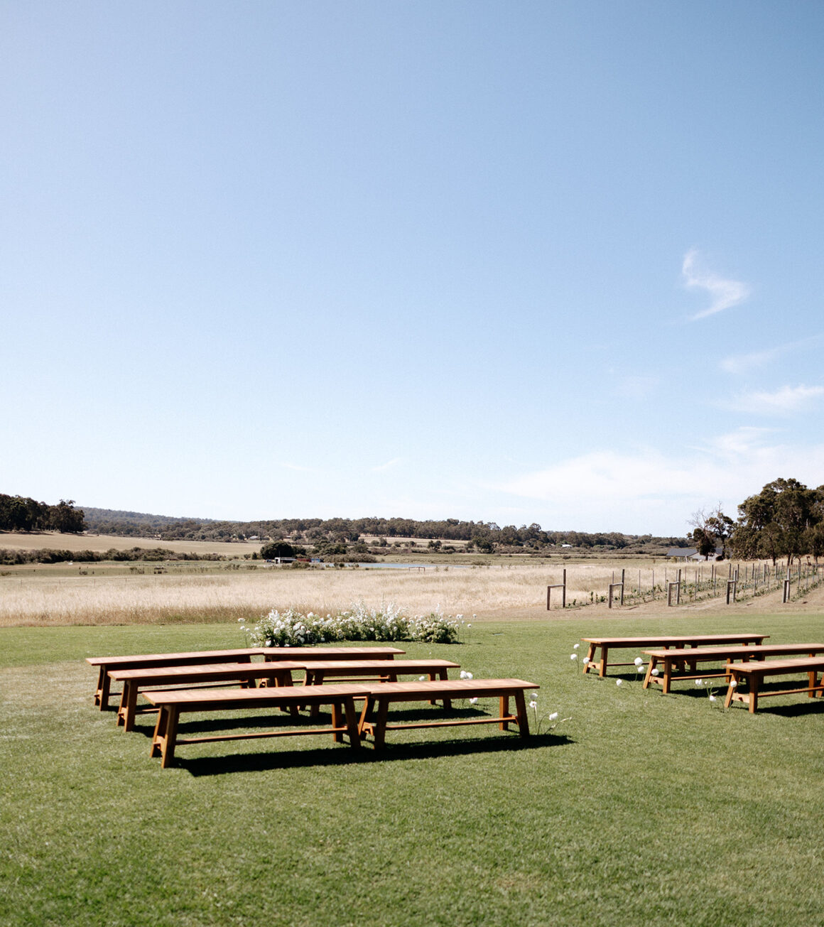 Relaxed outdoor wedding ceremony at The Tiller Farm with minimalist ground arbour