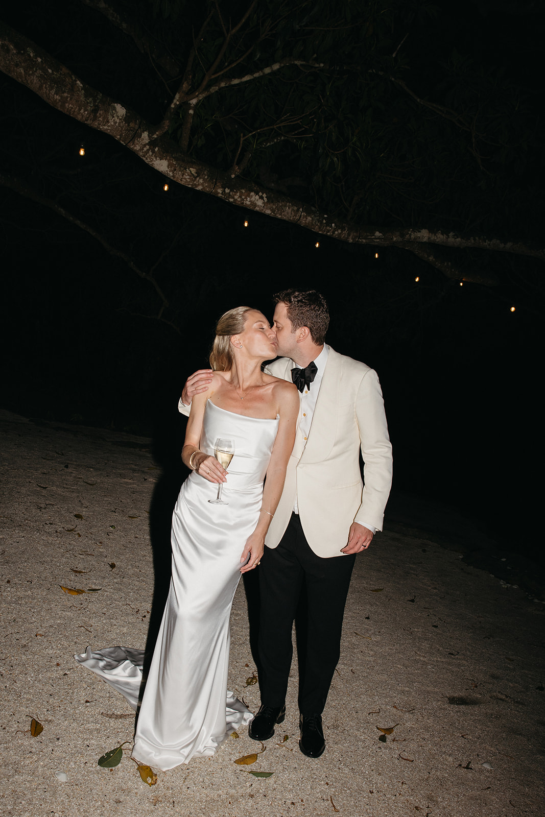 Newlyweds walking through Byron Bay hinterland at nightfall during their wedding reception