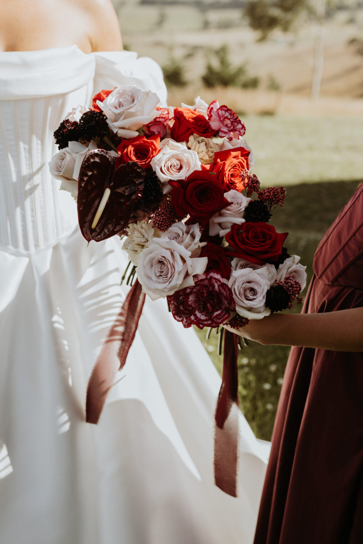 Bold wedding bouquet featuring vibrant seasonal blooms and textured foliage, perfect for statement bridal looks.