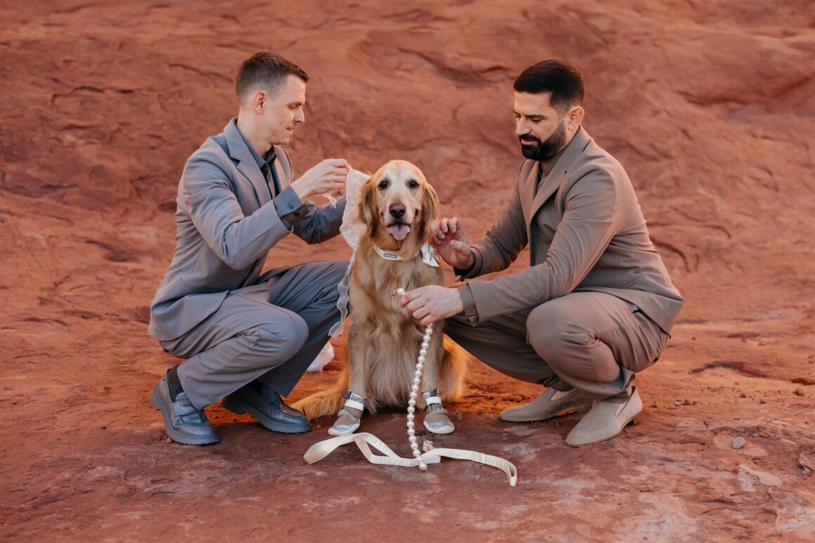 Intimate wedding moment with couple and dog during spiritual Moab desert ceremony