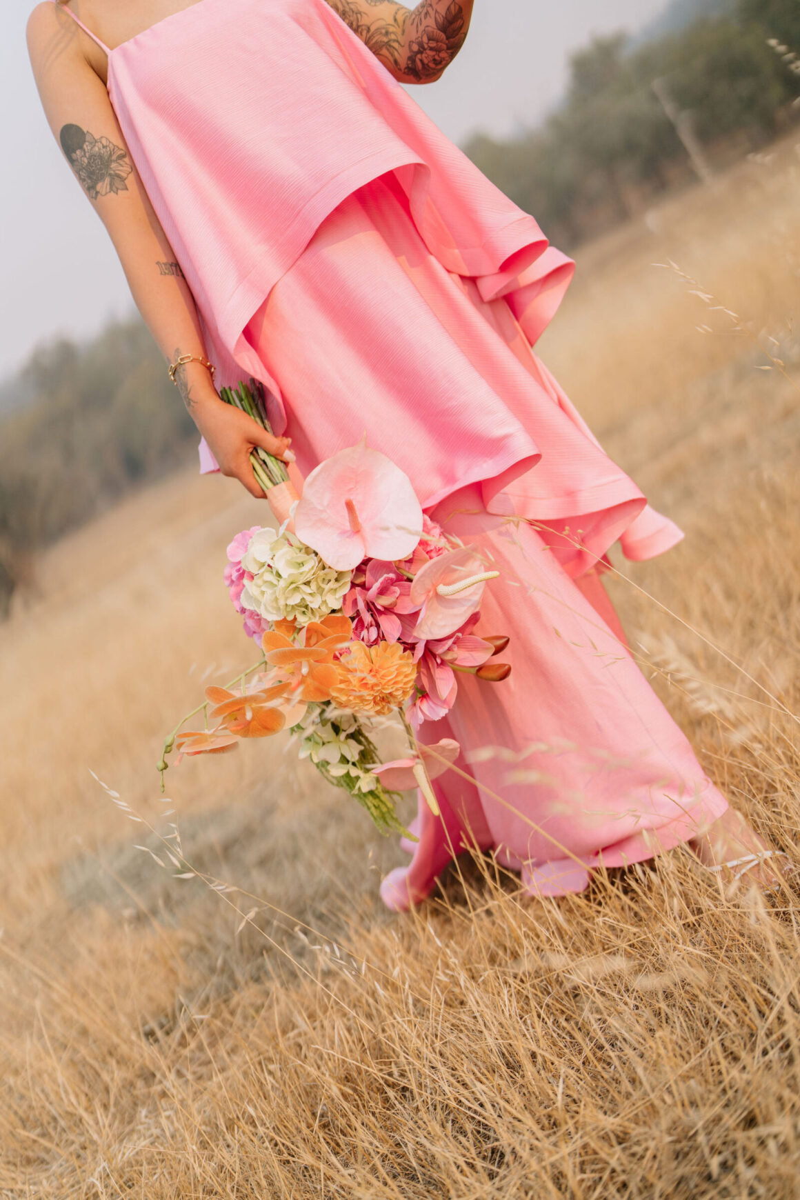 Colourful bridal fashion featuring non-traditional pink wedding dress 