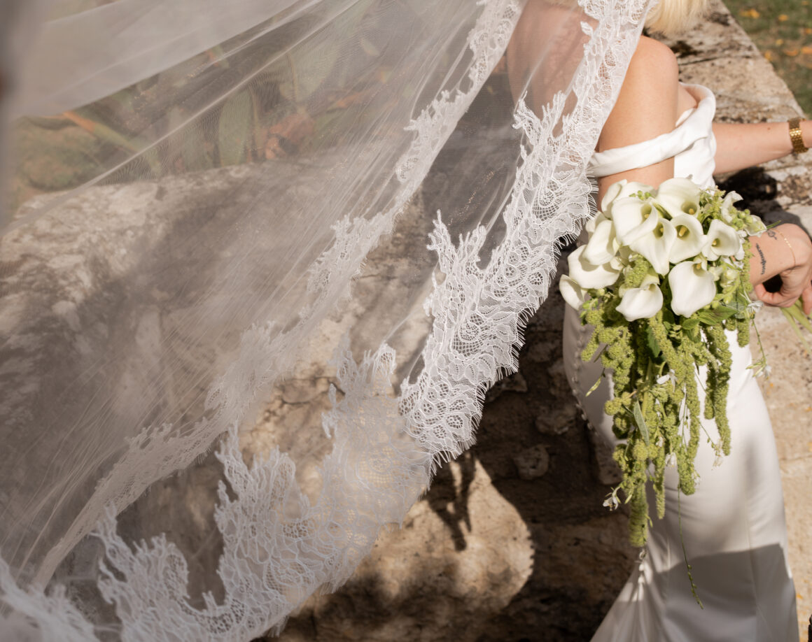 Bride in modern wedding gown walking through French chateau gardens